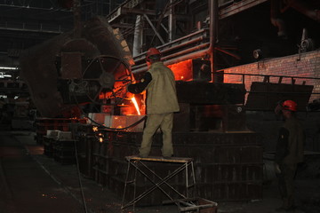 Work in the foundry. molten metal worker at a metallurgical plant