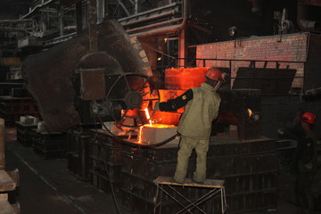 Work in the foundry. molten metal worker at a metallurgical plant