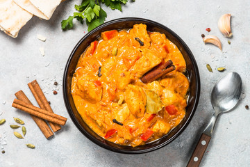 Chicken tikka masala with rice on black top view.