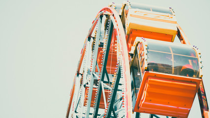 Old carousel, ferris wheel in an amusement park