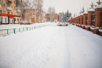 Fototapeta premium metal fence made of bricks. around the snow on the trees. winter day