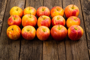apple fruits in a row, old weathered wood table background