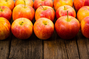 apple fruits in a row, old weathered wood table background