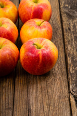 apple fruits in a row, old weathered wood table background