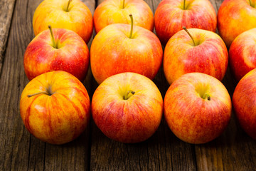 apple fruits in a row, old weathered wood table background