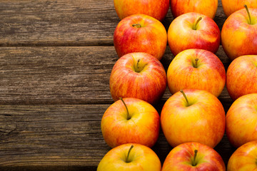 apple fruits in a row, old weathered wood table background
