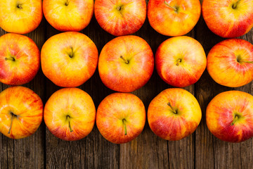 apple fruits in a row, old weathered wood table background