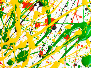 spilled paint spilled. yellow red black green.