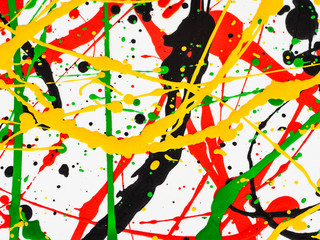 Art splashed spilled yellow green red black paint. expressionism.