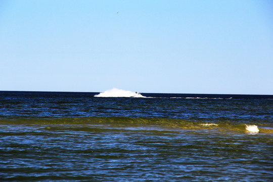 A large wave formed by an athlete on a hydrocycle
