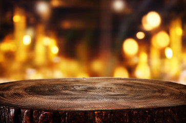 background of wooden table in front of abstract blurred restaurant lights