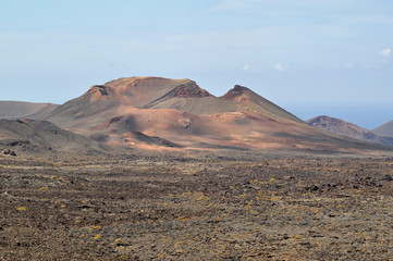 Fototapeta na wymiar Amazing volcanic landscape of Timanfaya National Park. Lanzarote, Canary Islands, Spain