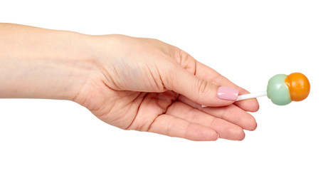 Hand with color lollipop, bright cool candy.