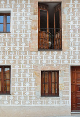 Facade of old building with decorative patterns and wooden doors