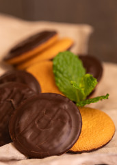 Jaffa cakes, cookies covered with dark chocolate and filled with raspberry marmalade. Sweet background.