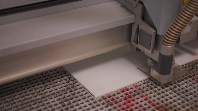Close Up of Modern Precise Exact Laser Cutter Working on Cutting White Plastic