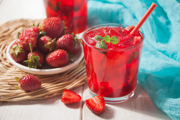 Glasses with fresh homemade strawberry sweet iced tea or cocktail, lemonade with mint. Refreshing cold drink. Summer pool party. Marine theme.