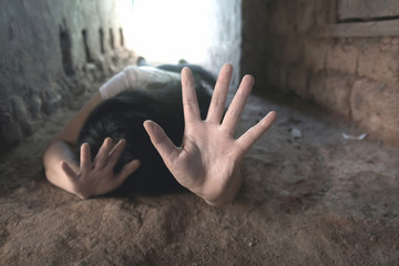 woman laying on floors with show gesture of stop harassment and violence