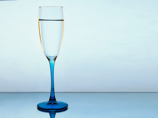 Elegant picture of a glass of pure water on a blue background