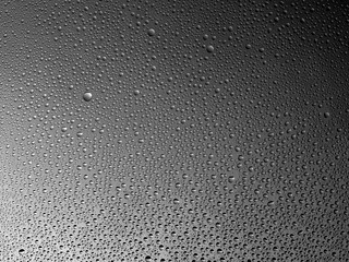 Water droplets on the glass with a colored background. Drops of water.