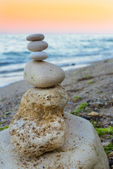Relax time. Sunset at black sea. Rocky coast near Varna in Bulgarian. Stack of pebbles.