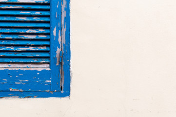 Blue wooden closed window on a white wall