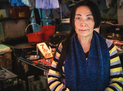 Old Asian Woman Standing Outside Of A Hong Kong Meat Market