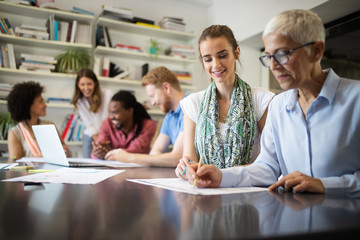 Group of business people collaborating on project in office