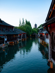  Wuzhen China, traditional houses sorrounding a water canal with reflection from the blue sky