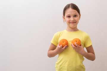 little girl with juicy oranges