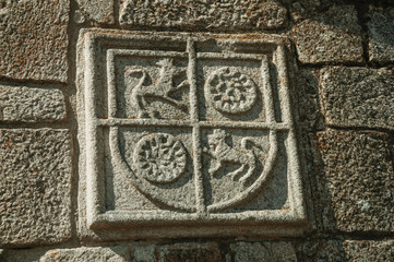 Family coat of arms carved on stone in a medieval chapel