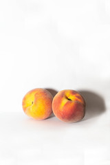 red peaches on white background