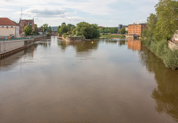 Fototapeta na wymiar River Weser from the Münster bridge (Münsterbrücke) with the little island Hameln Lower Saxony (Niedersachsen)