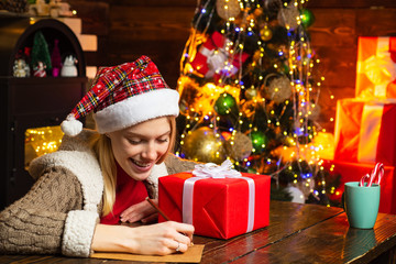 Writing letter. Woman wooden interior christmas decorations garland lights. Christmas tree. Happiness cheer and love. Girl enjoy cozy atmosphere christmas eve. Noel. Pleasant moments. Christmas joy