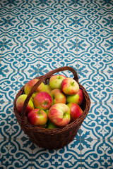 basket of apple on kitchen tile floor, vignette frame