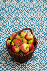 basket of apple on kitchen tile floor