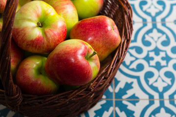 basket of apple on kitchen tile floor