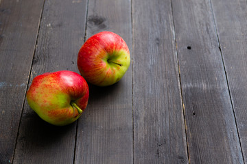 two apples on black wooden background