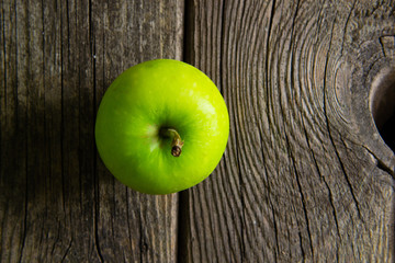 green apples on old wooden background