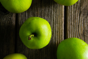 green apples on old wooden background