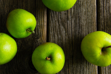 green apples on old wooden background