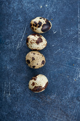 Quail eggs. Black background. Top view. Free space.