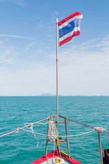 Front head of the boat above the sea with Thai flag background