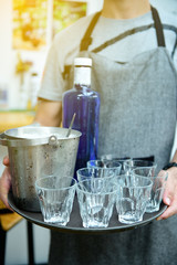 Male employees are serving glass and ice buckets for customers. Service with a smiling face