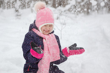 Young girl in the winter snowy forest.