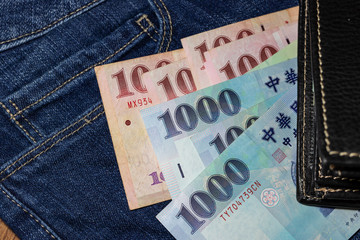 Obraz premium Taiwanese money, Taiwan Banknote, Taiwan dollar on jean background.