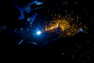 A skilled welder who is manufacturing car parts.