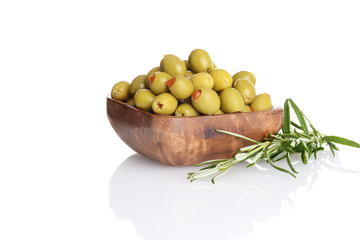 wood bowl of pimento green olives with rosemary herb