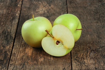 Fresh green apples on old wooden floors