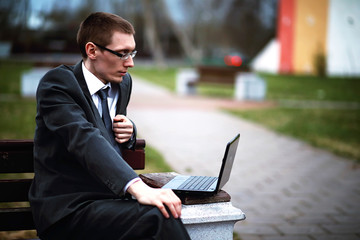 A man in a suit lies on a brick floor